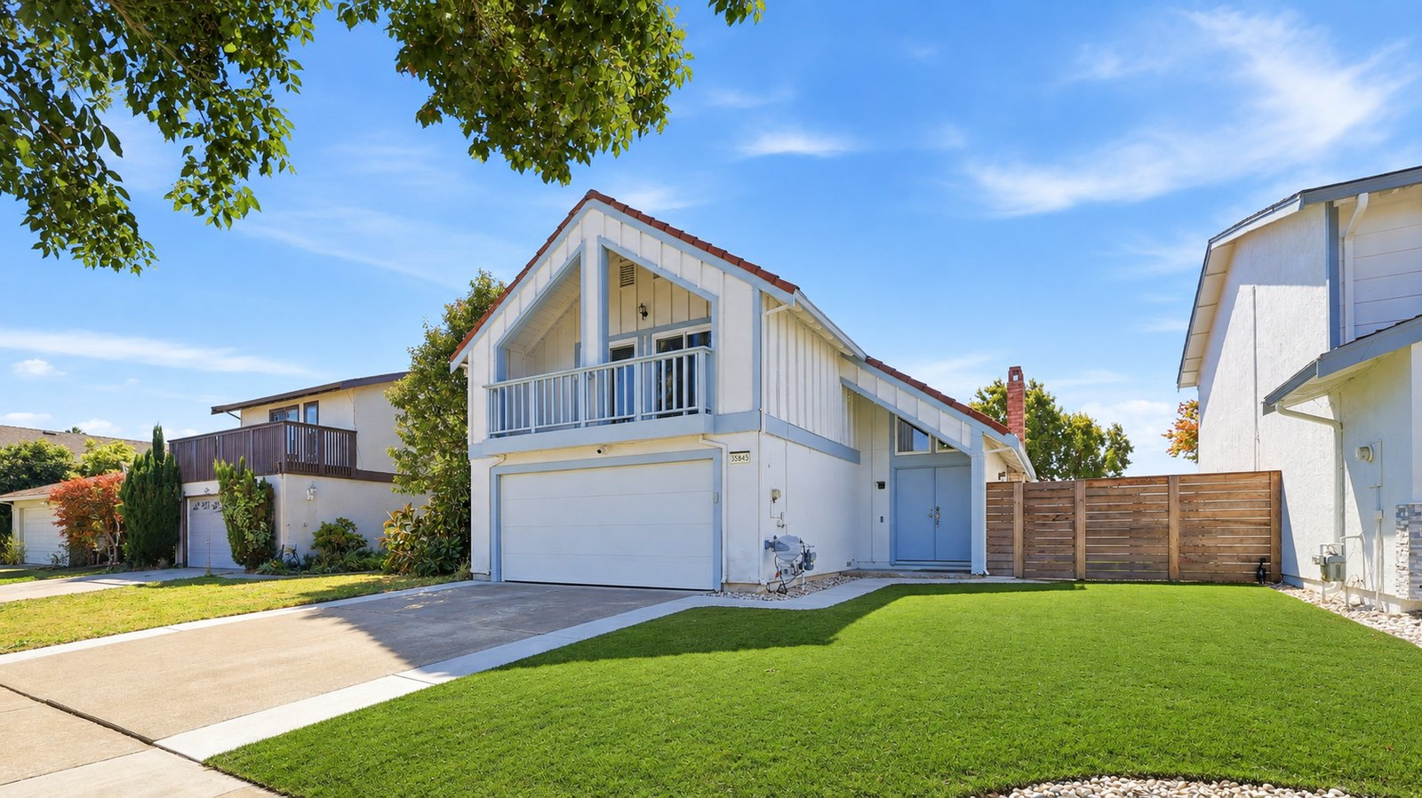 Front exterior of 35845 Tozier St, a two-story home in Newark with a tile roof, upstairs balcony and new front lawn